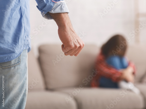Close up of man fist and crying little girl