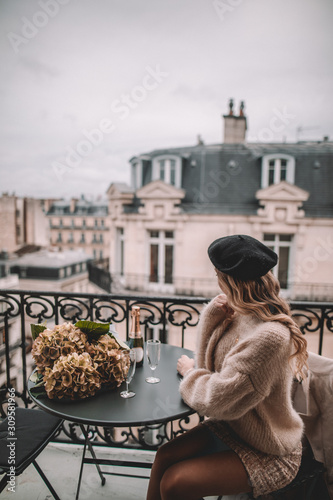 Young woman with blonde hairon Paris balcony 