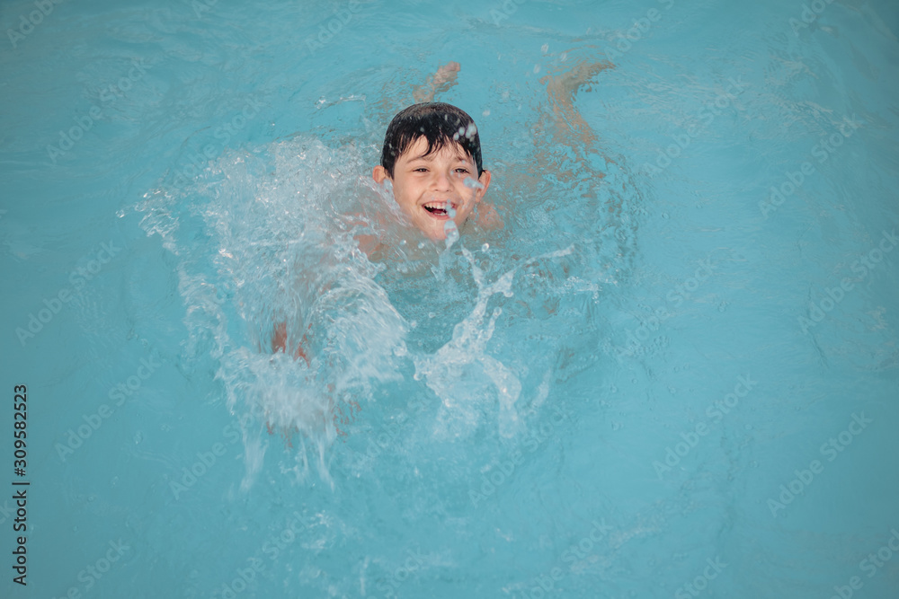 Boy playing in a swimming pool