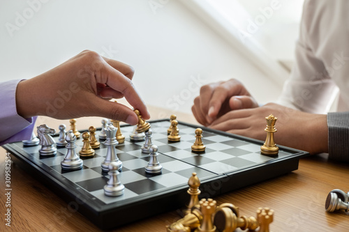 hand of businessman moving chess in competition, shows leadership, followers and business success strategies photo