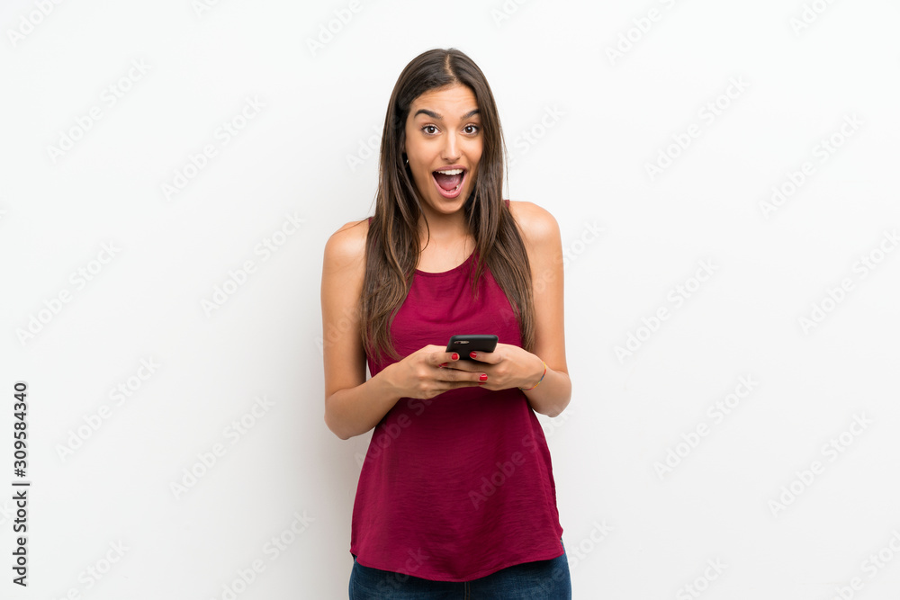 Young woman over isolated white background using mobile phone Young woman over isolated white background using mobile phone