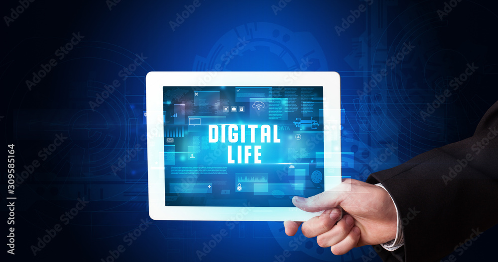 Young business person working on tablet and shows the digital sign: DIGITAL LIFE Young business person working on tablet and shows the digital sign: DIGITAL LIFE
