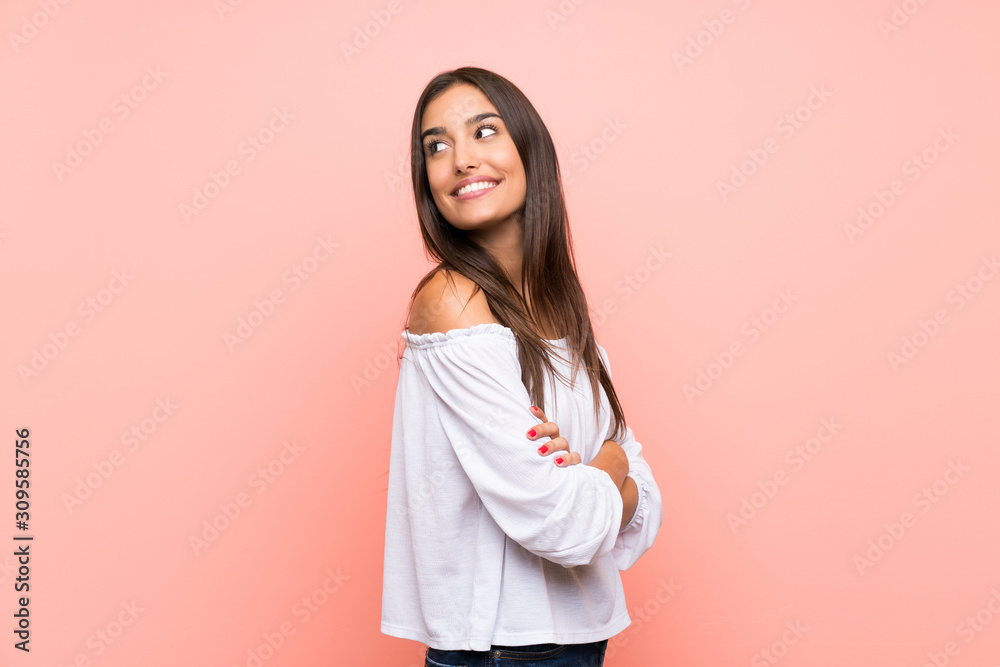 Young woman over isolated pink background with arms crossed and happy Young woman over isolated pink background with arms crossed and happy