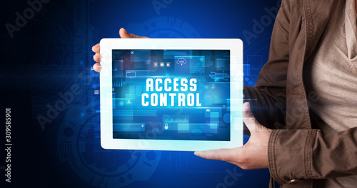 Wallpaper Mural Young business person working on tablet and shows the digital sign: ACCESS CONTROL Torontodigital.ca