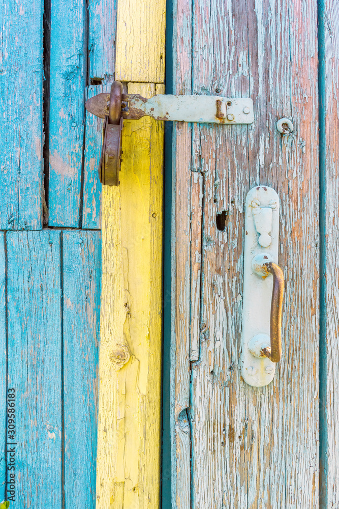 iron lock on wooden battered door of an old country house