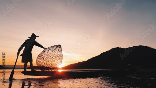 Fisherman and Mekong River,Traditional fishing boat on the lake at sunrise- Thailand, Mekong River, Laos, Vietnam, Myanmar