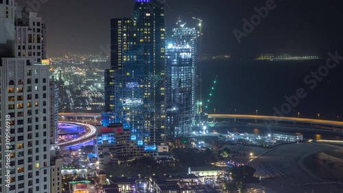 Wallpaper Mural Waterfront overview Jumeirah Beach Residence JBR skyline aerial night timelapse with illuminated skyscrapers. Shops, restaurants and other entertainment from above with traffic Torontodigital.ca