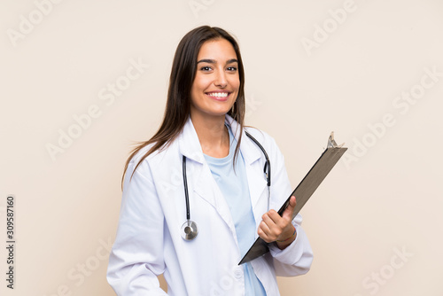 Young doctor woman over isolated background holding a folder photo