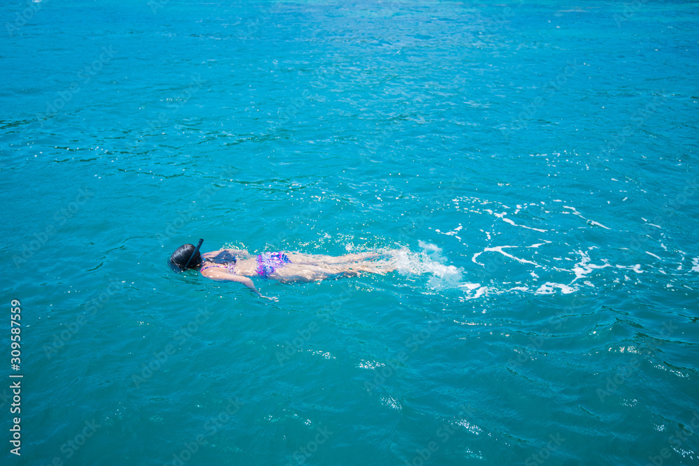 Young woman in bikini snorkeling