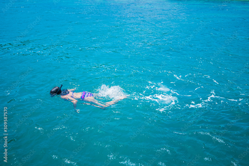 Young woman in bikini snorkeling