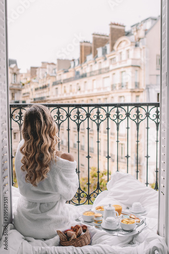 Young woman with blonde hair on balcony in Paris France
