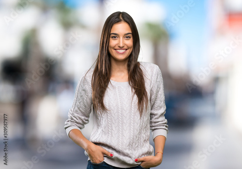 Billede på lærred Young hispanic brunette woman laughing at outdoors