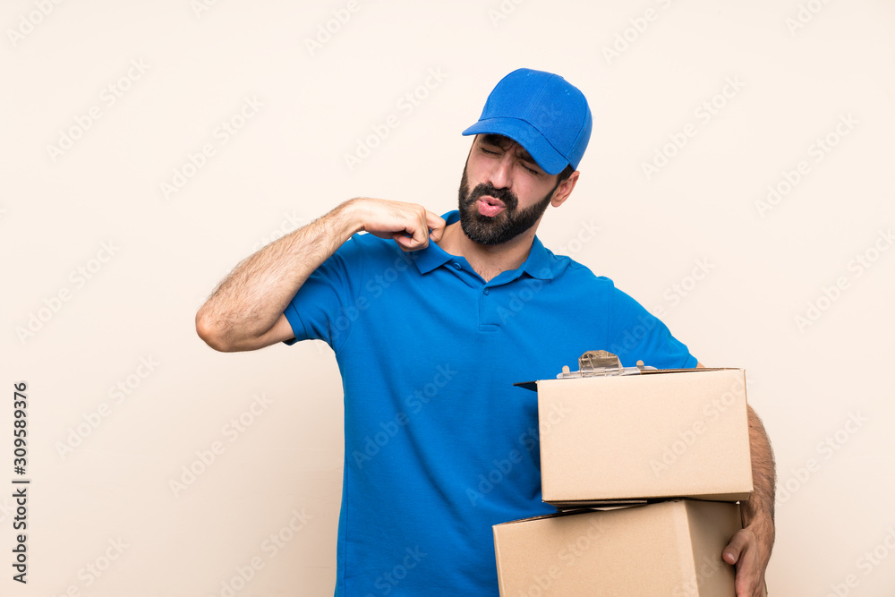 Delivery man with beard over isolated background with tired and sick expression Delivery man with beard over isolated background with tired and sick expression