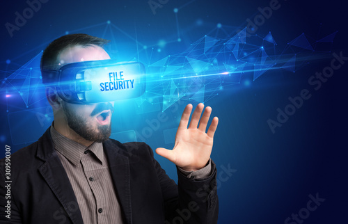 Businessman looking through Virtual Reality glasses with FILE SECURITY inscription, cyber security concept