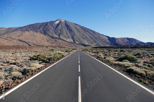 Straight empty road with volcano Teide in the background in Teide National Park  Tenerife  Spain.