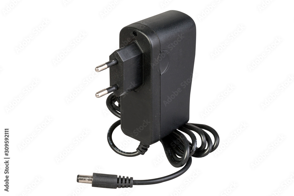 Black power adapter with cable and DC power supply connector for low current devices. on a white background. Black power adapter with cable and DC power supply connector for low current devices. on a white background.