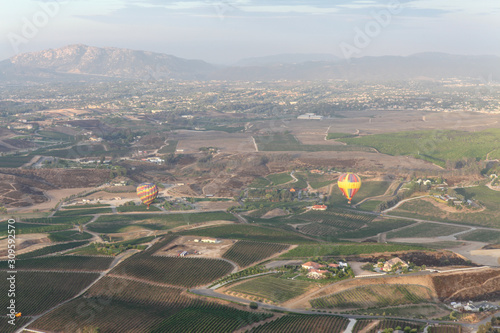 Hot air balloon fly over vine yards 