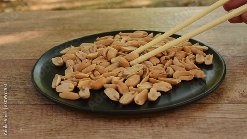 salt peanut on plate picking by chopticks photo