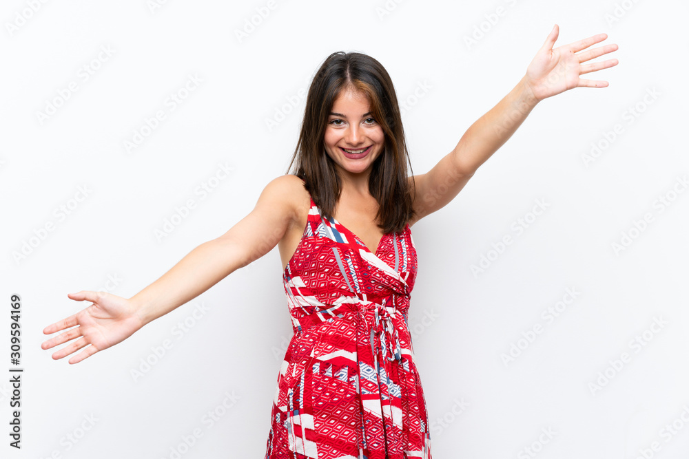 Caucasian girl in red dress over isolated white wall presenting and inviting to come with hand Caucasian girl in red dress over isolated white wall presenting and inviting to come with hand