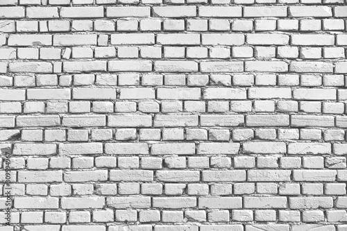 White brick wall texture background. Old weathered and cracked bricks. Close up
