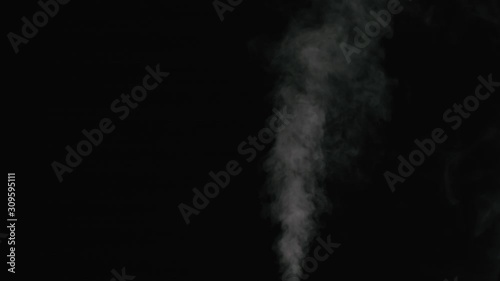 Slow motion thin water mist stream over black background