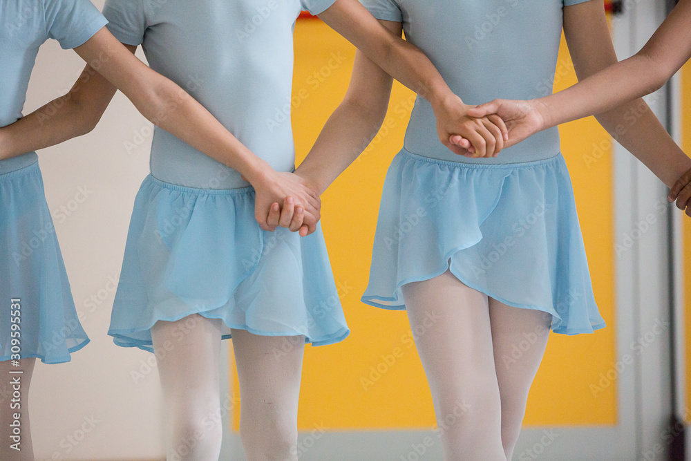 Detail of the hands of dancers holding each other tight during a rehearsal of a show Detail of the hands of dancers holding each other tight during a rehearsal of a show