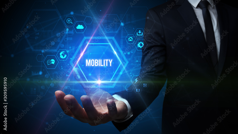 Man hand holding MOBILITY inscription, social media concept Man hand holding MOBILITY inscription, social media concept
