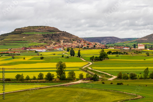 Scenic Castrojeriz springtime view on the Way of St. James, Camino de Santiago in Castile and Leon, Spain under overcast May sky photo