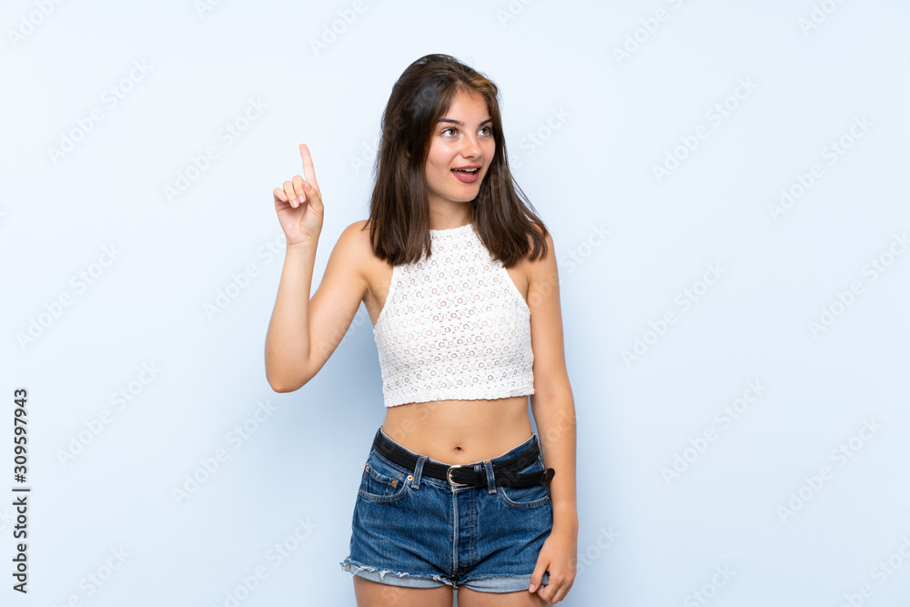 Young woman over isolated blue background intending to realizes the solution while lifting a finger up Young woman over isolated blue background intending to realizes the solution while lifting a finger up