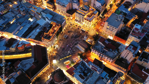 Aerial drone night photo of illuminated popular tourist area in Athens metropolitan centre at dusk with beautiful colours, Attica, Greece