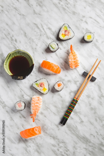 Sushi composition on marble background top view.