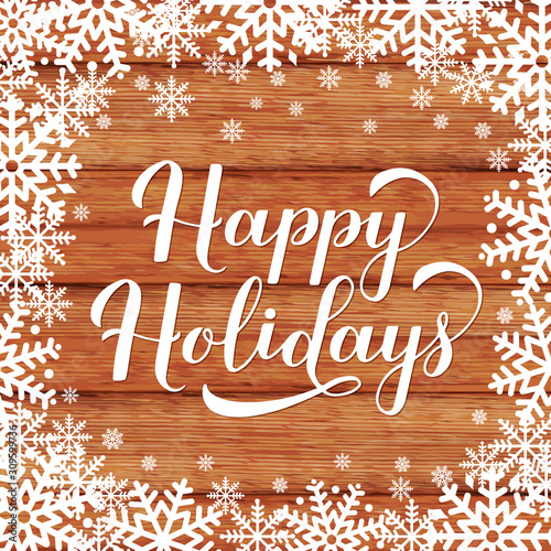Happy Holidays calligraphy hand lettering on wood background with snowflakes. Merry Christmas and Happy New Year typography poster. Easy to edit vector template for greeting card, banner, flyer, etc.