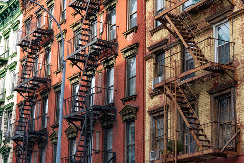 Row of Colorful Old Brick Buildings in the East Village of New York City with Fire Escapes