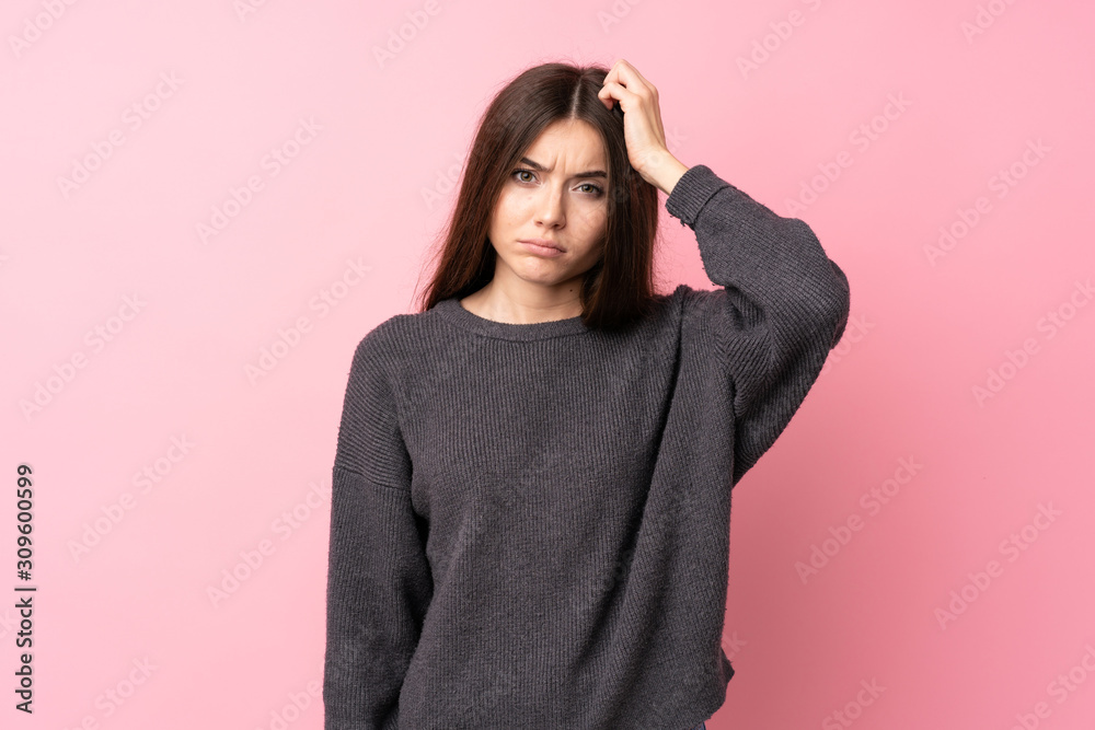 Fototapeta premium Young woman over isolated pink background with an expression of frustration and not understanding