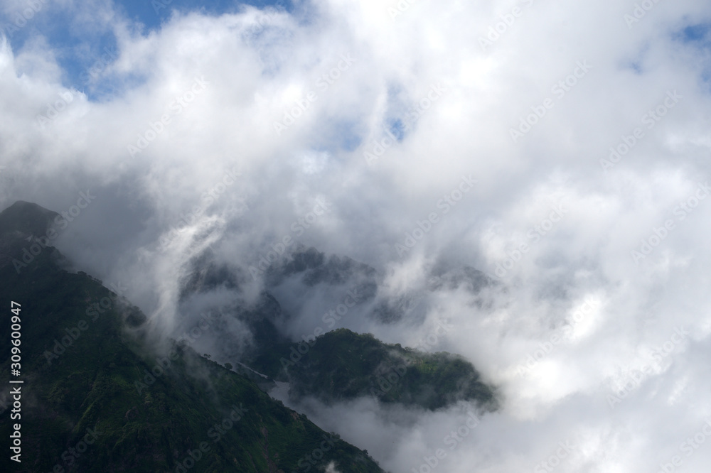 view from a mountain of clouds over mountains