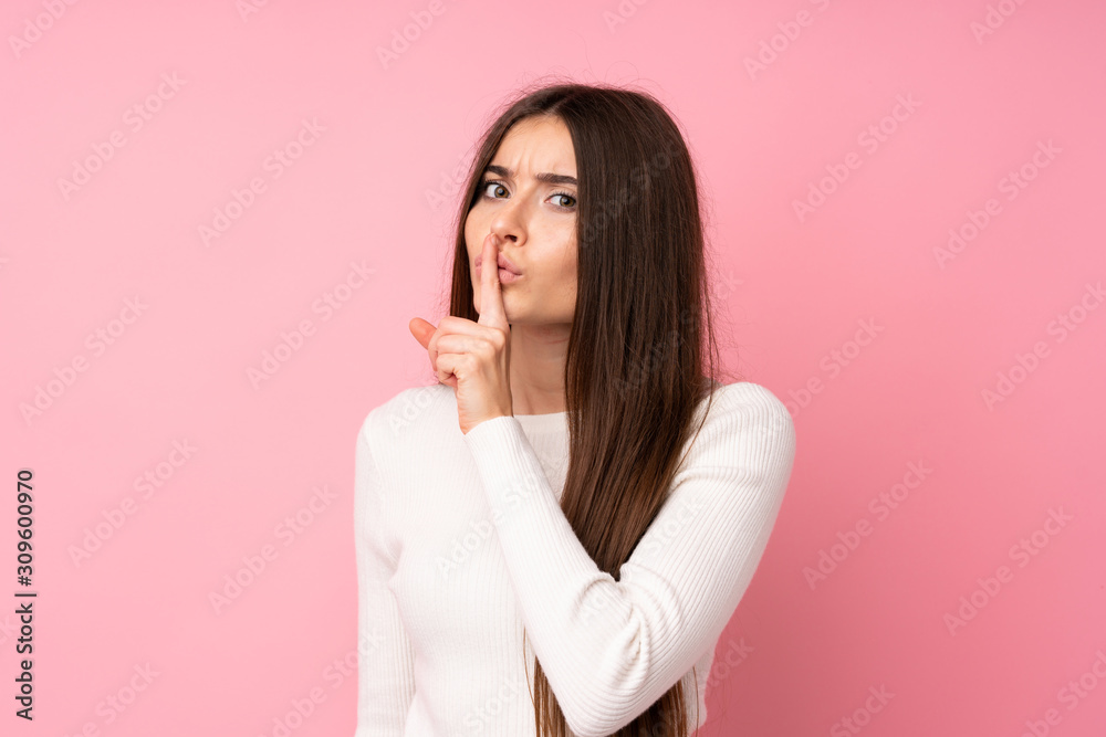 Young woman over isolated pink background doing silence gesture Young woman over isolated pink background doing silence gesture