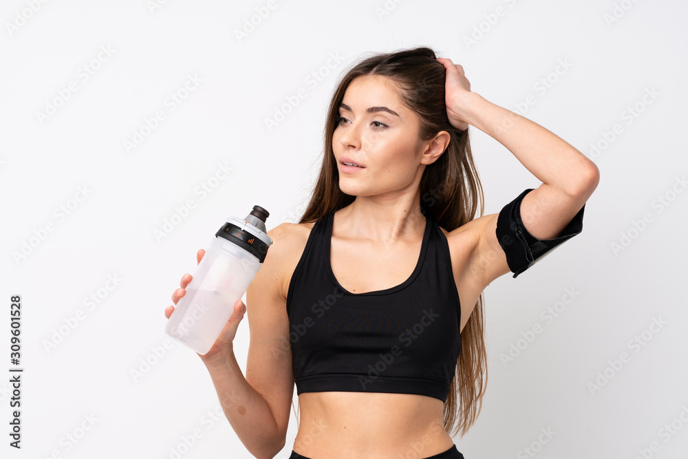 Young sport woman over isolated white background with sports water bottle Young sport woman over isolated white background with sports water bottle
