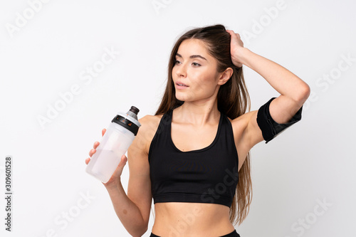 Young sport woman over isolated white background with sports water bottle