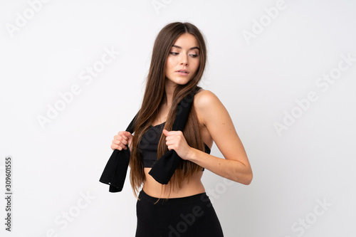 Young sport woman over isolated white background with sport towel