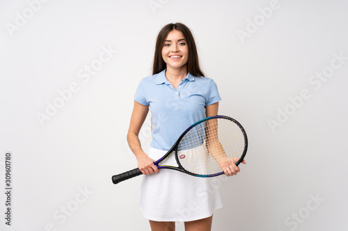 Young girl over isolated white wall playing tennis © luismolinero