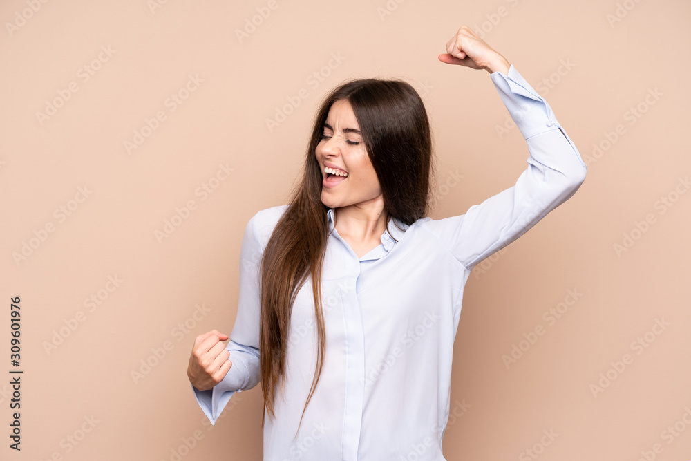 Young woman over isolated background celebrating a victory Young woman over isolated background celebrating a victory