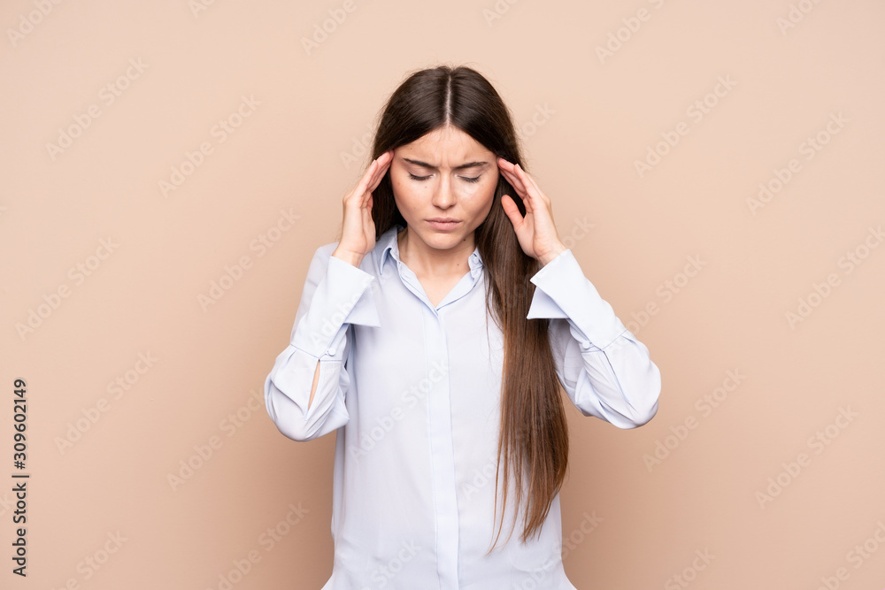 Young woman over isolated background with headache Young woman over isolated background with headache