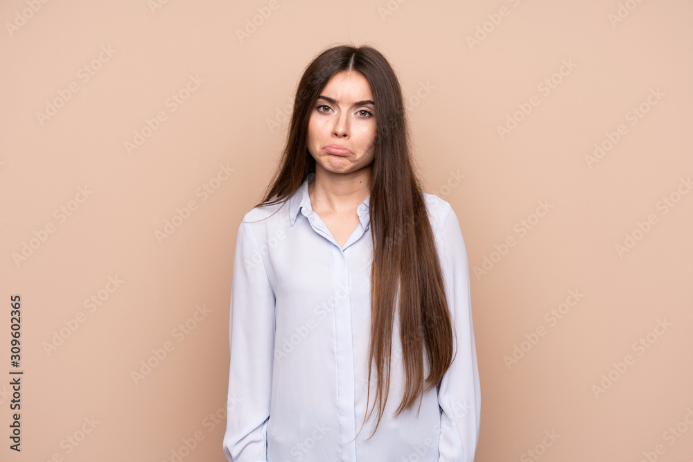 Young woman over isolated background with sad and depressed expression Young woman over isolated background with sad and depressed expression