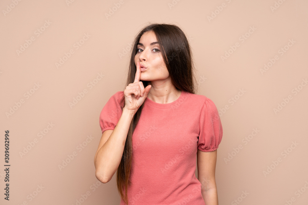 Young woman over isolated background doing silence gesture Young woman over isolated background doing silence gesture