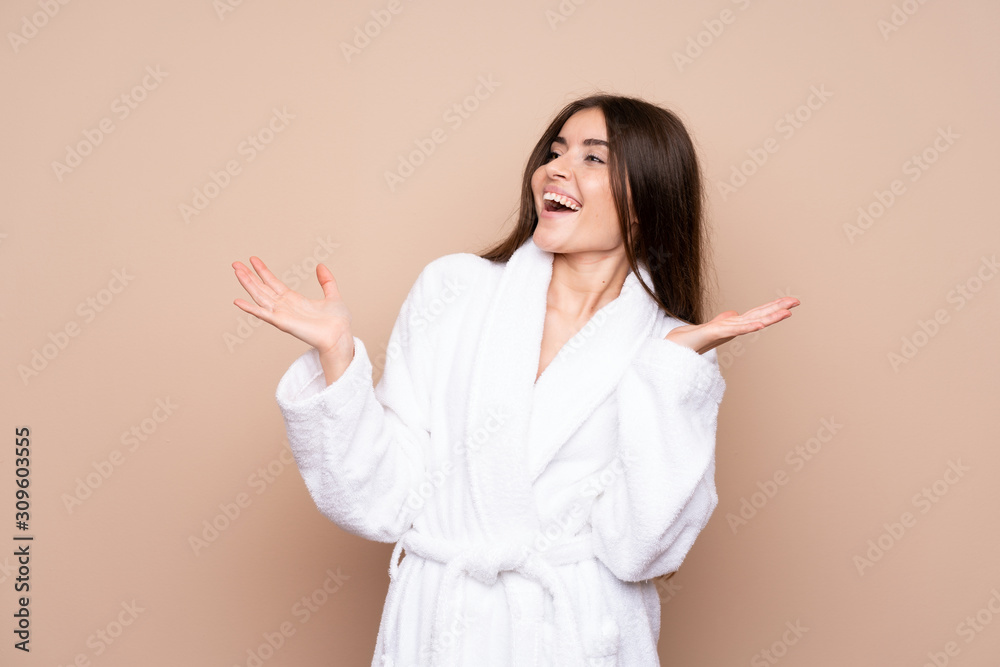 Young girl in a bathrobe over isolated background with surprise facial expression Young girl in a bathrobe over isolated background with surprise facial expression