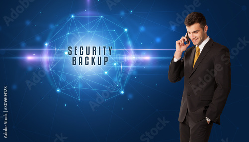 Businessman thinking about security solutions with SECURITY BACKUP inscription