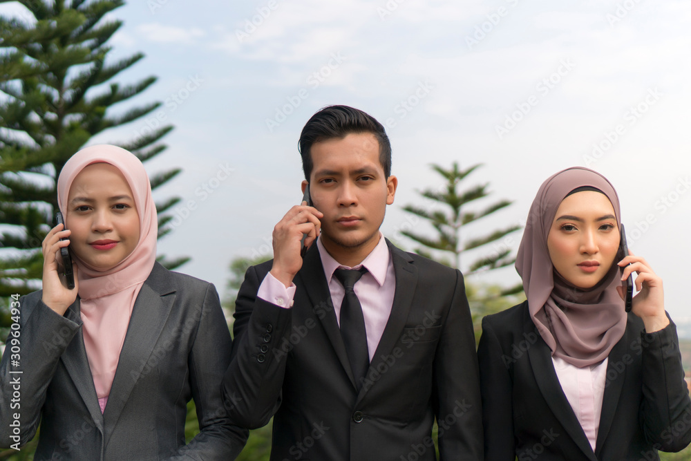 Young Asian Malay Executive at the park wearing suit
