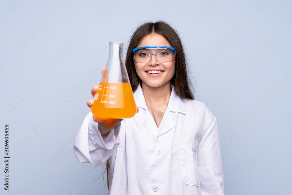 Young woman over isolated blue background with a scientific test tube Young woman over isolated blue background with a scientific test tube