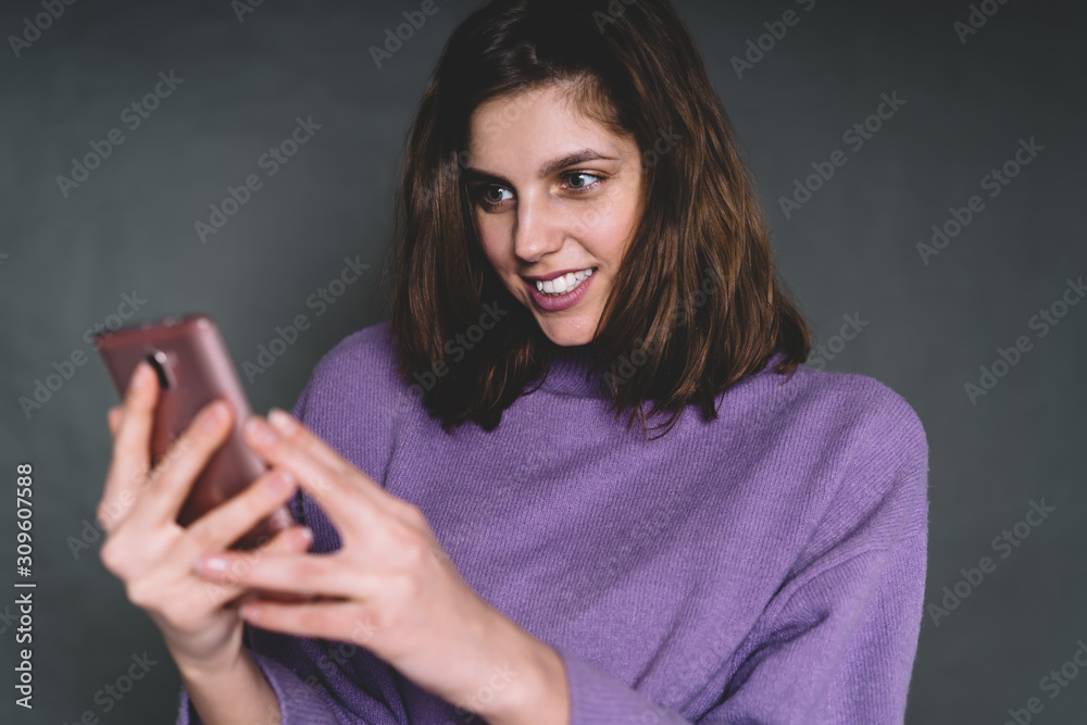 Smiling young woman surfing internet on smartphone Smiling young woman surfing internet on smartphone
