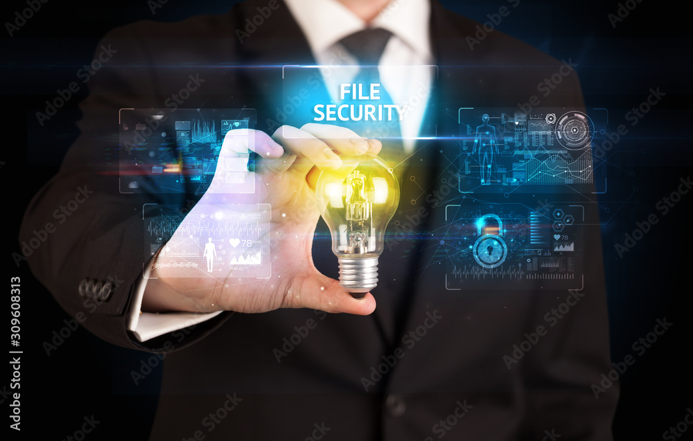 Businessman holding lightbulb with FILE SECURITY inscription, online security idea concept Businessman holding lightbulb with FILE SECURITY inscription, online security idea concept